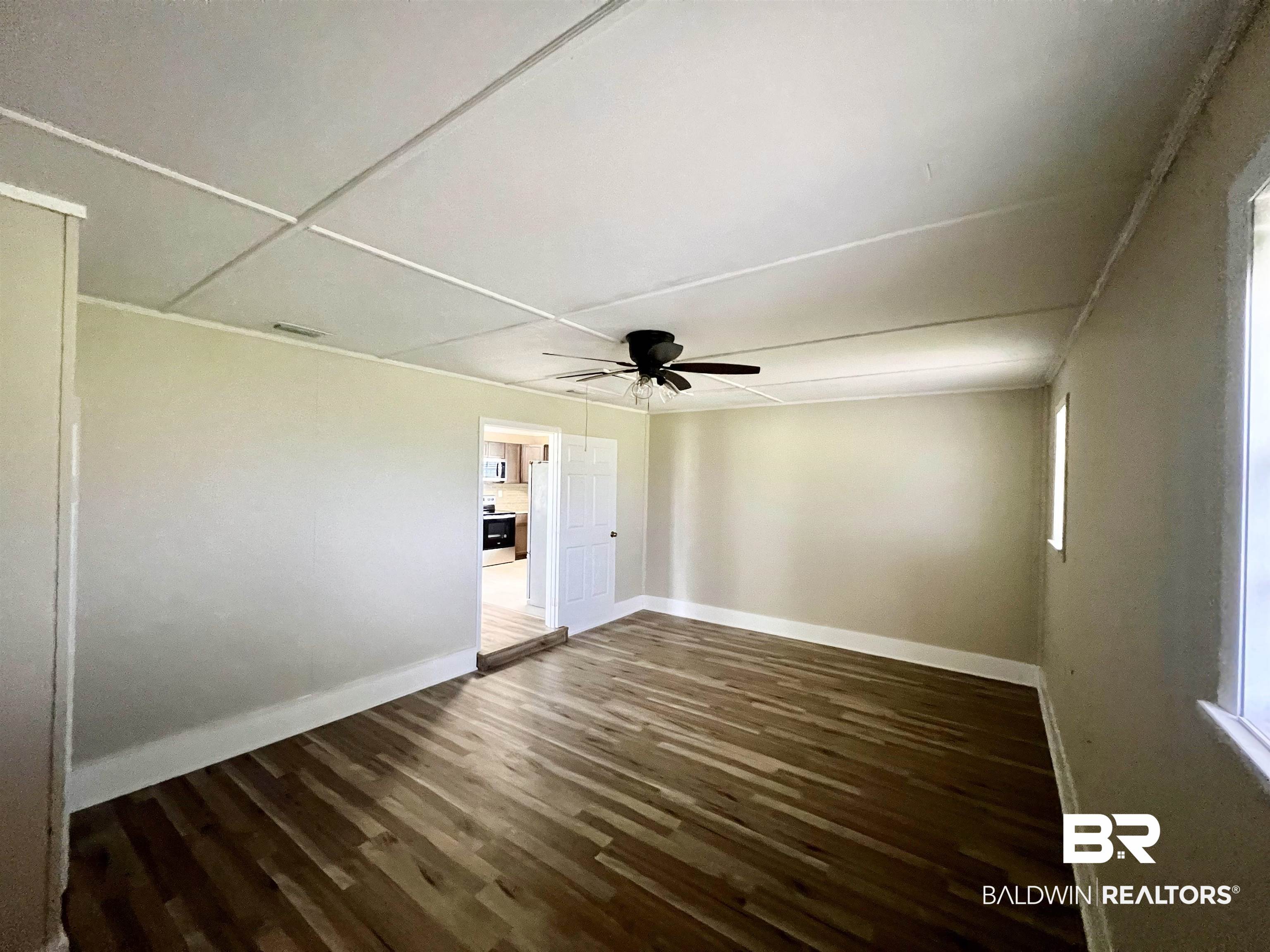 508 Freemanville Drive Atmore, AL 36502 - Photo 23 of 27 Unfurnished room featuring ceiling fan and hardwood / wood-style floors