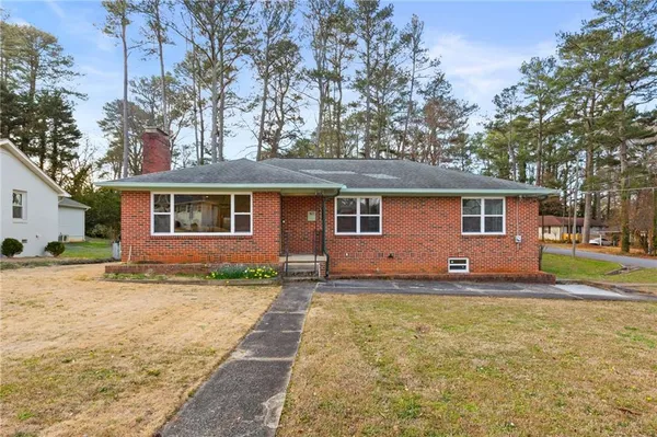 a view of a yard with a house and a large tree