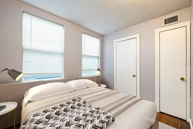 a bedroom with a bed and a window