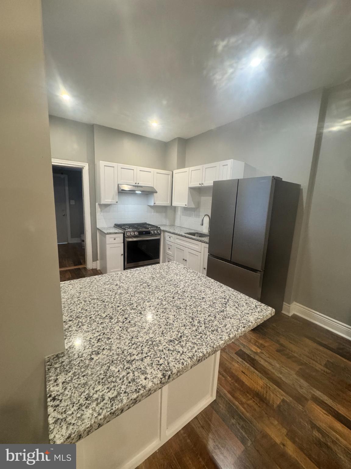 1908 West Somerset Street Philadelphia, PA 19132 - Photo 9 of 10 a living room with stainless steel appliances kitchen island granite countertop furniture and a fireplace