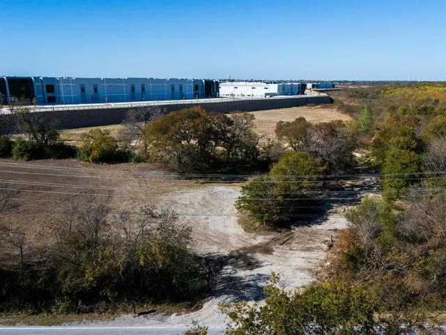 a view of a dirt road with trees