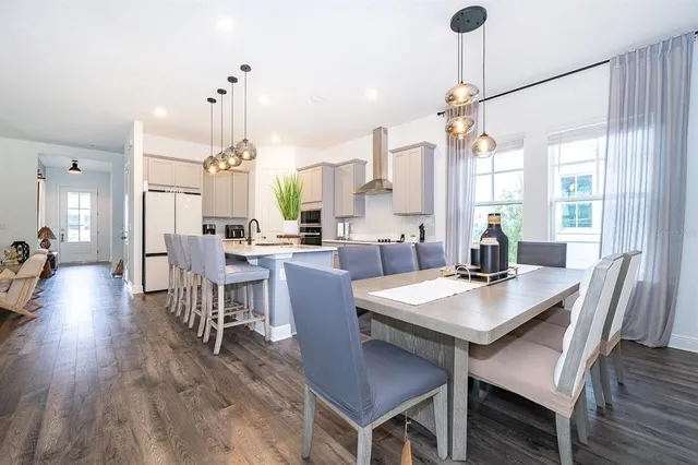 a view of a dining room with furniture window and wooden floor
