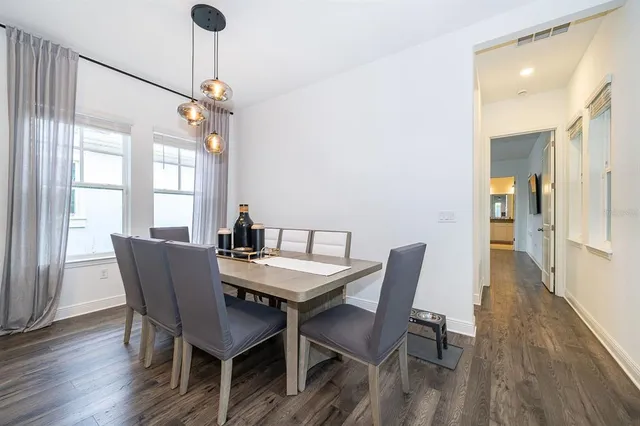 a view of a dining room with furniture window and wooden floor