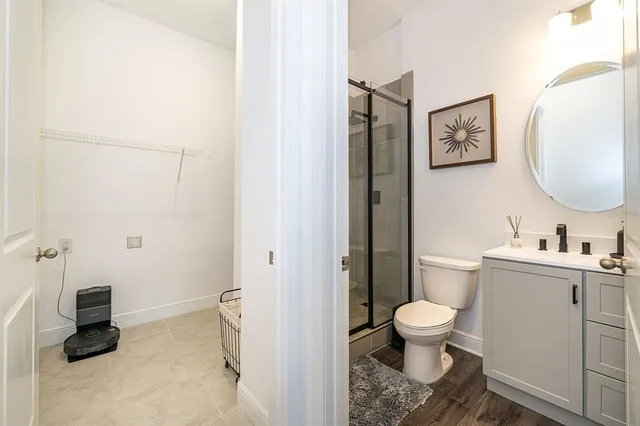 a bathroom with a sink toilet and a mirror