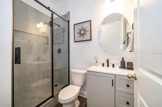 a bathroom with a toilet sink and shower