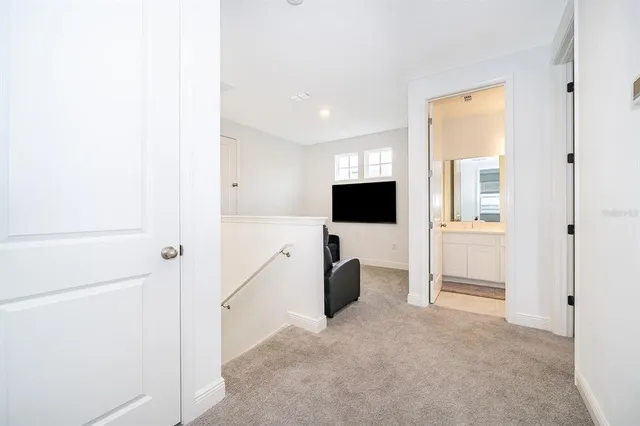 a view of kitchen with furniture and refrigerator
