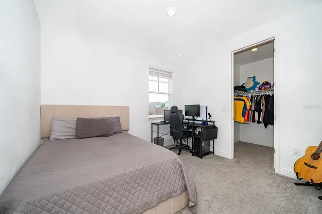 a bedroom with a bed and a chair