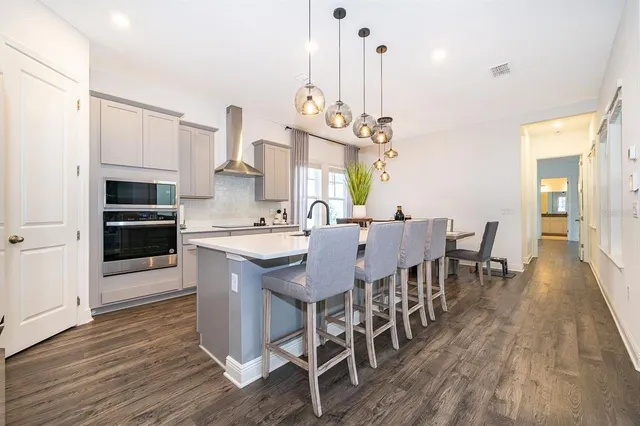 a large kitchen with a table and chairs