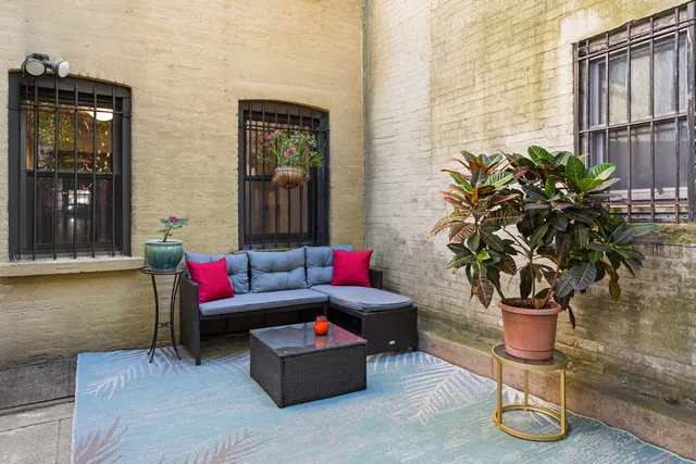 a living room with furniture and a potted plant