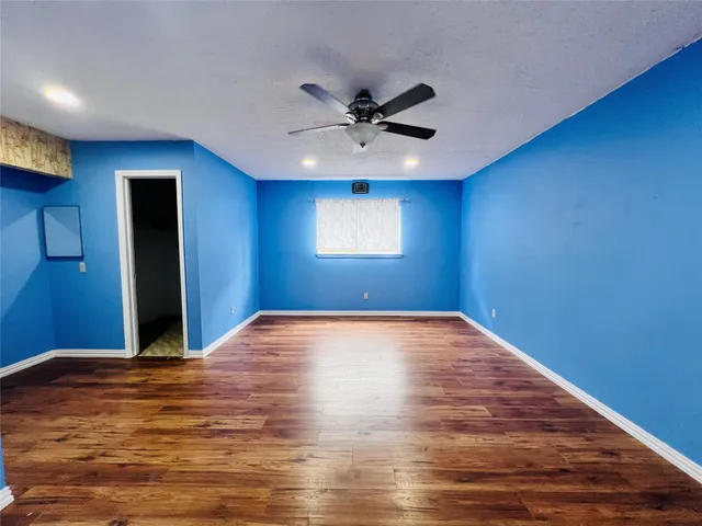 a bedroom with a bed and a ceiling fan