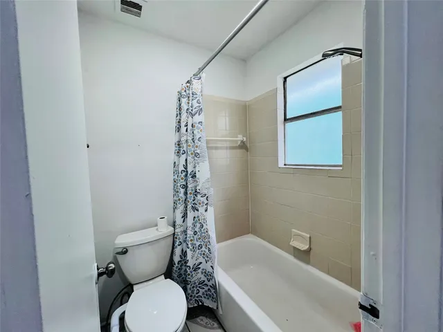 a view of room with wooden floor and fan