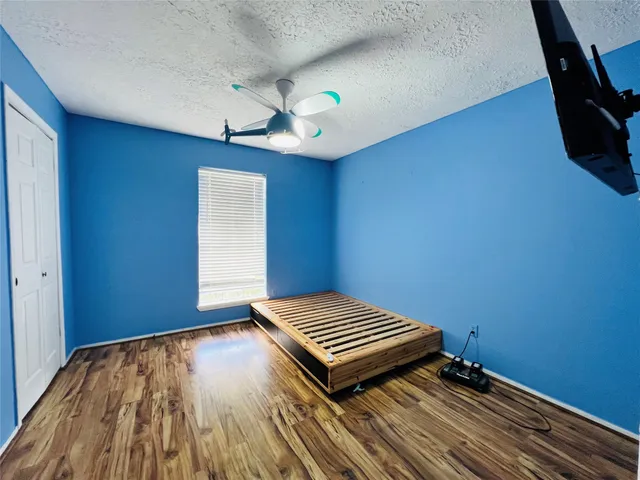 a view of empty room with wooden floor