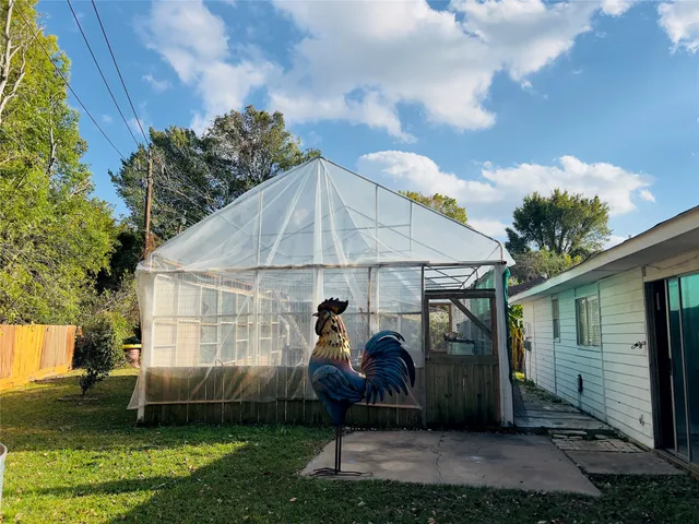 a view of a livingroom with wooden floor and a ceiling fan