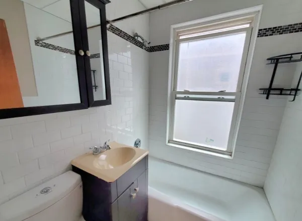a bathroom with a sink a vanity and a bathtub