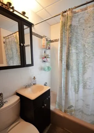 a bathroom with a sink vanity toilet and a mirror