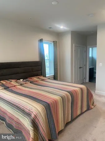 a bedroom with a bed and a mirror