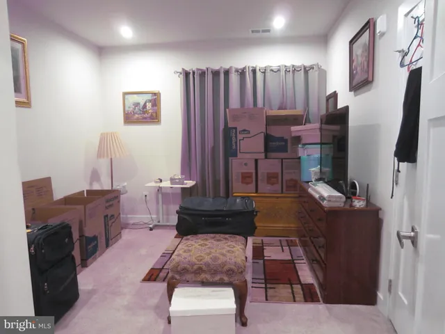 a living room with furniture rug and wooden floor
