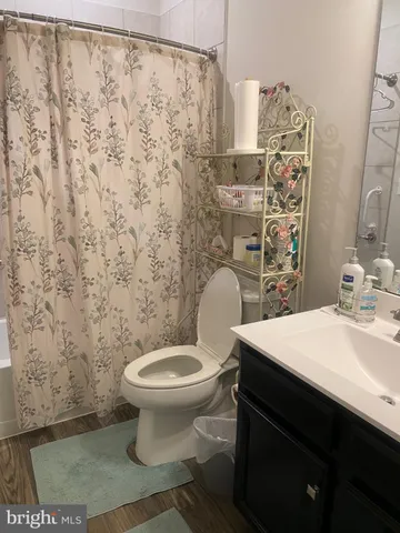 a bathroom with a sink toilet and a mirror