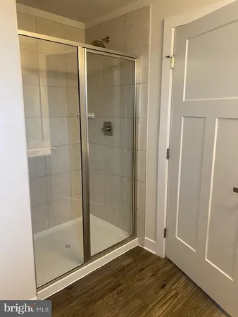 a bathroom with a glass shower door