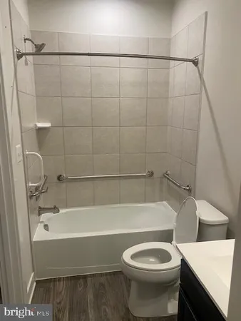 a bathroom with a toilet and a bathtub