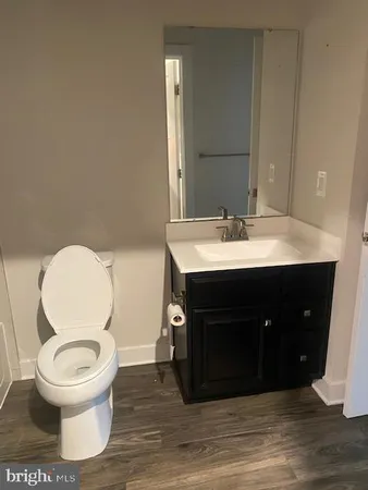 a bathroom with a toilet a sink and mirror