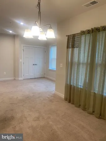 a view of a livingroom with a chandelier fan
