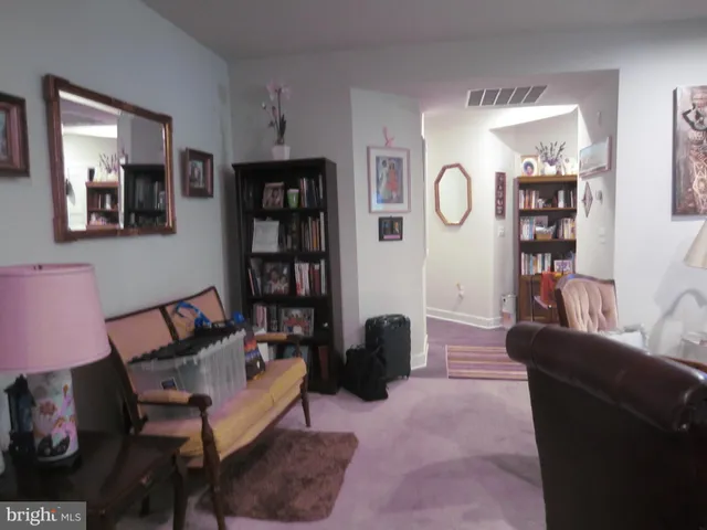 a living room with furniture a lamp and lots of furniture