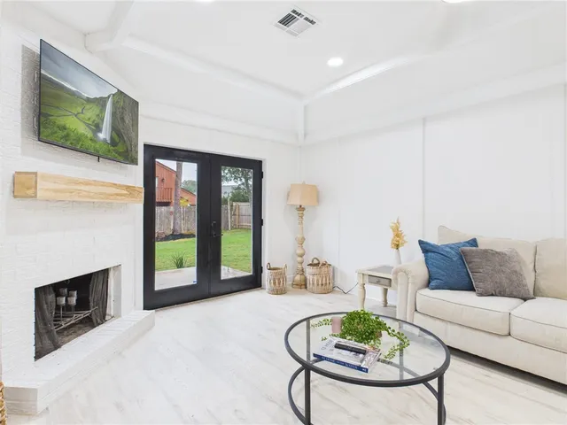 a living room with furniture and kitchen view