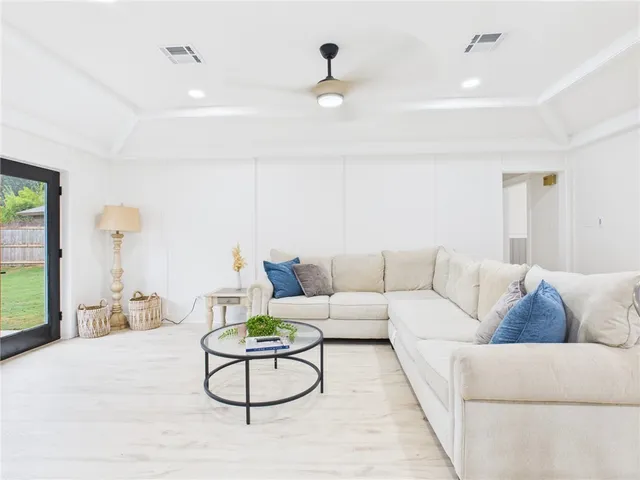 a living room with furniture and kitchen view