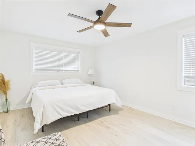 a bedroom with a bed and chair