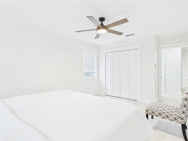 a bedroom with a bed and a large window