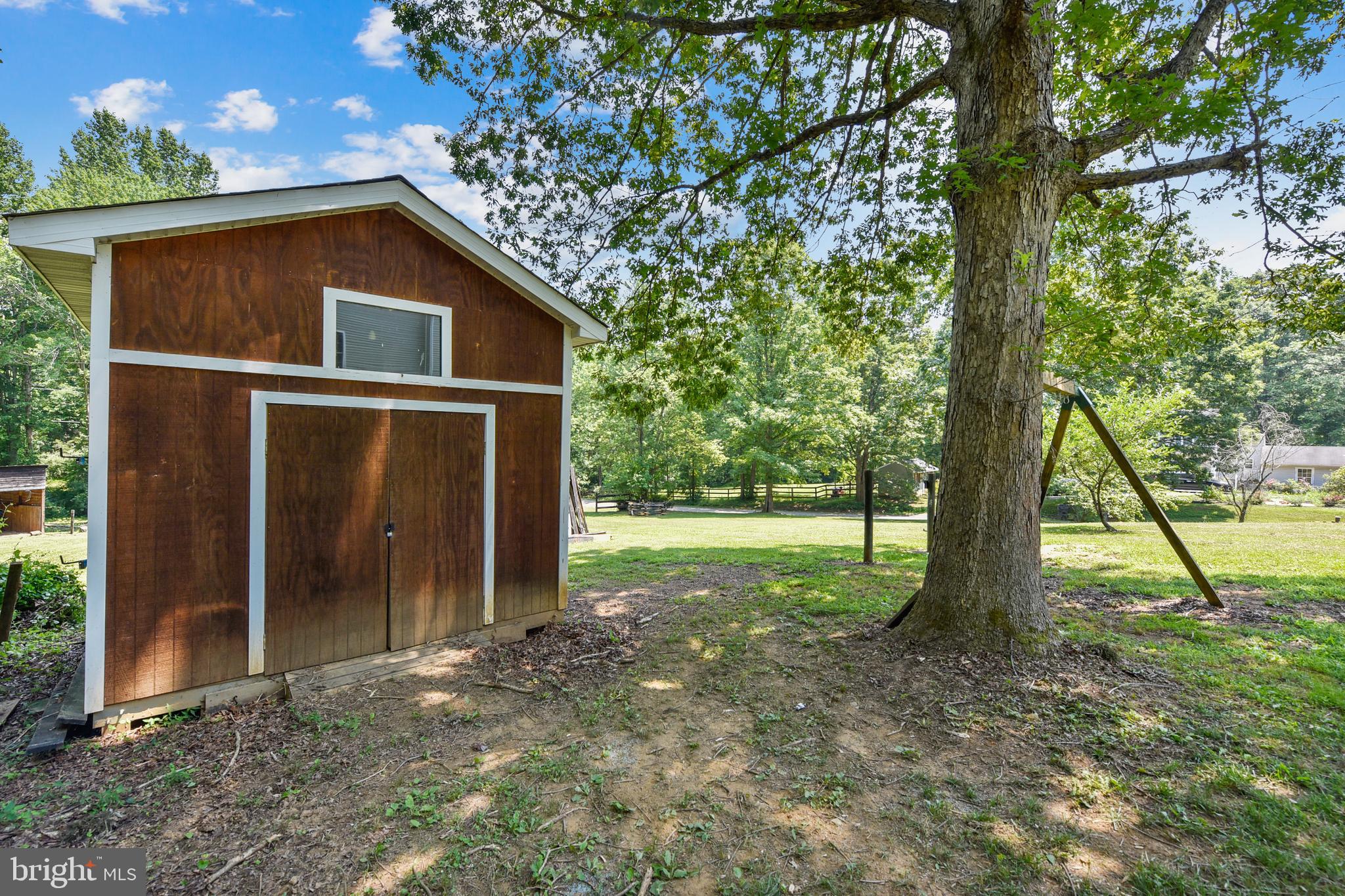 14518 Thickett Ridge Lane Rixeyville, VA 22737 - Photo 8 of 20 Storage shed and riding mower