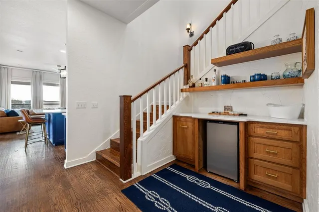 a view of an entryway with wooden floor and staircase