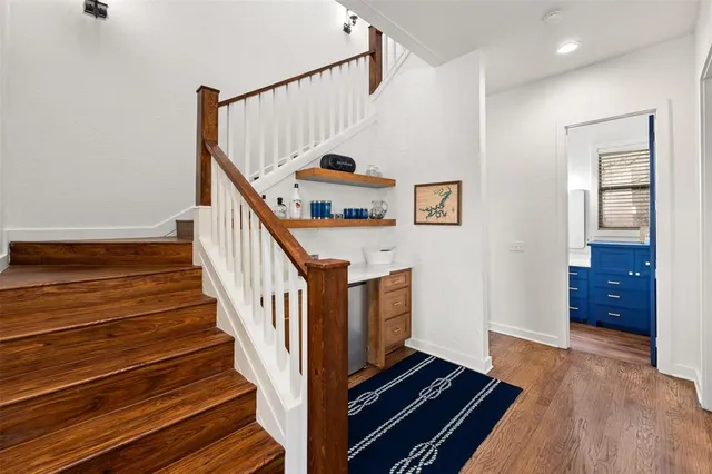 a view of entryway and hall with wooden floor