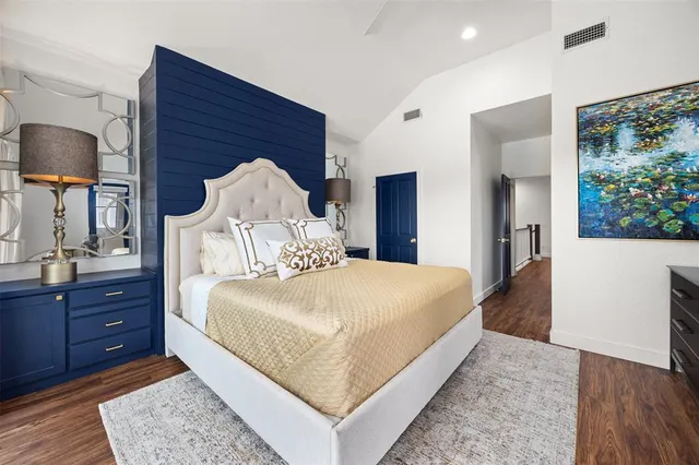 a bedroom with a bed and a dresser