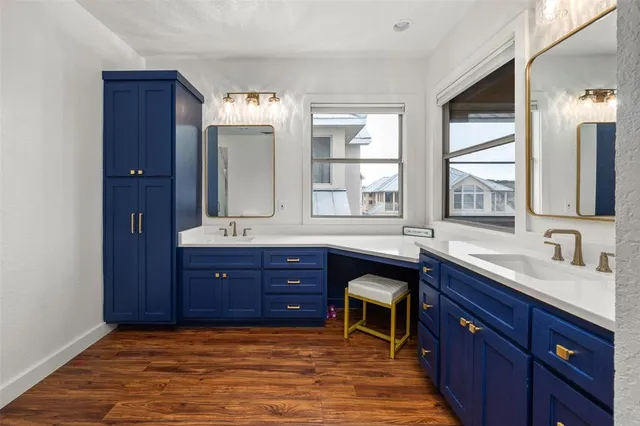 a spacious bathroom with double vanity and a mirror