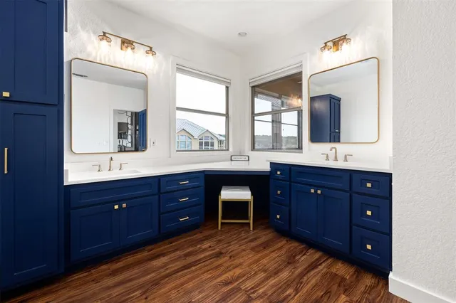 a spacious bathroom with a double vanity sink and a mirror