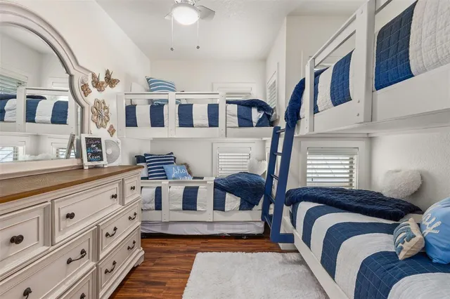 a spacious bedroom with a bed and a dresser