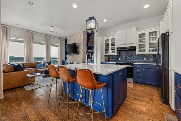 a large kitchen with lots of counter space and windows