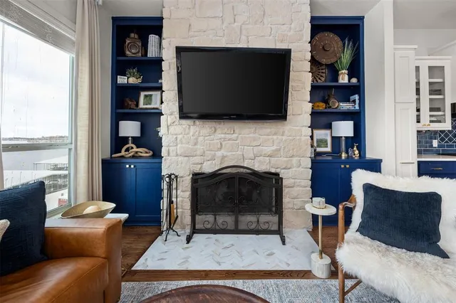 a living room with furniture a flat screen tv and a fireplace
