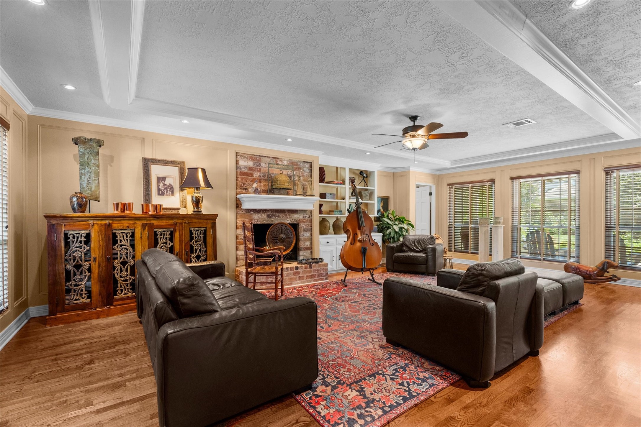 9103 Herts Road Spring, TX 77379 - Photo 6 of 46 This is classic Champion Forest! Wood floors, brick-accented fireplace, and built-in cabinetry crate a warm and inviting place to relax or gather.