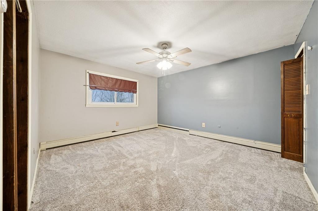 709 Westover Road Westover, PA 16692 - Photo 19 of 41 an empty room with windows and fan
