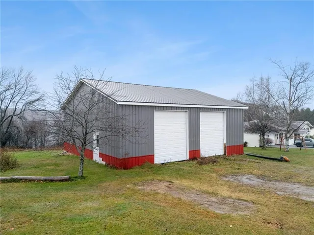 a front view of house with yard and garage