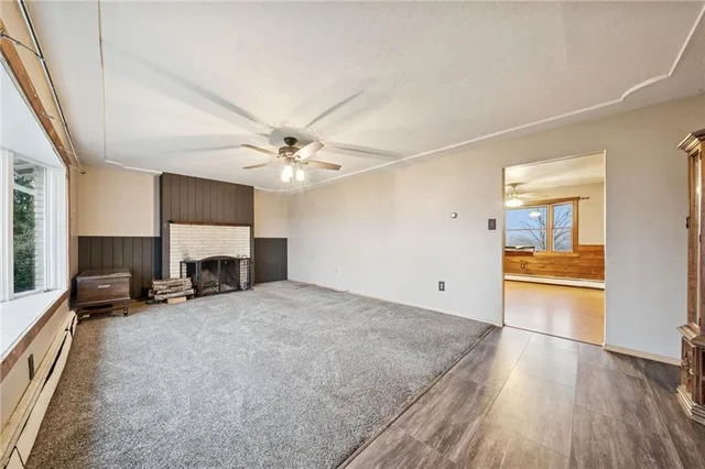 a view of a livingroom with furniture and an empty room