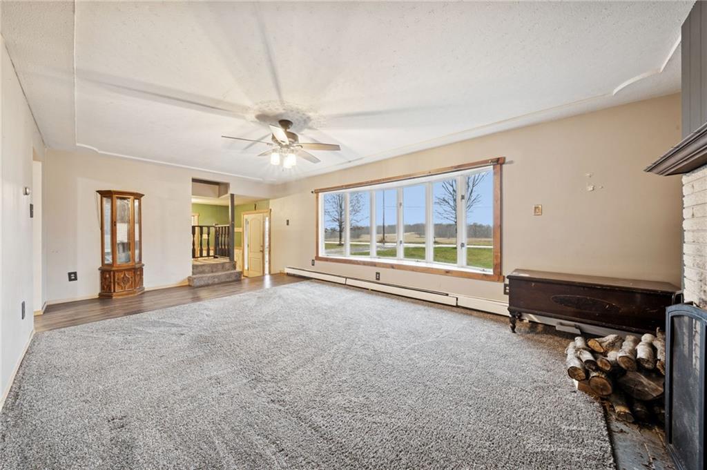 709 Westover Road Westover, PA 16692 - Photo 7 of 41 a view of an empty room with a fireplace and a large window