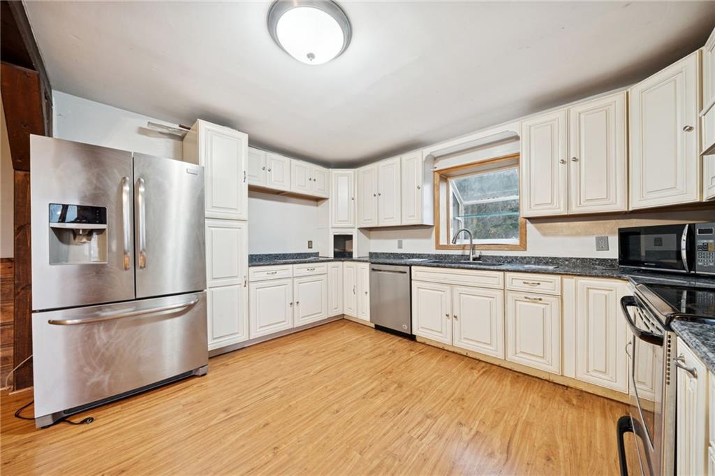 709 Westover Road Westover, PA 16692 - Photo 10 of 41 a kitchen with granite countertop a refrigerator stove top oven and sink