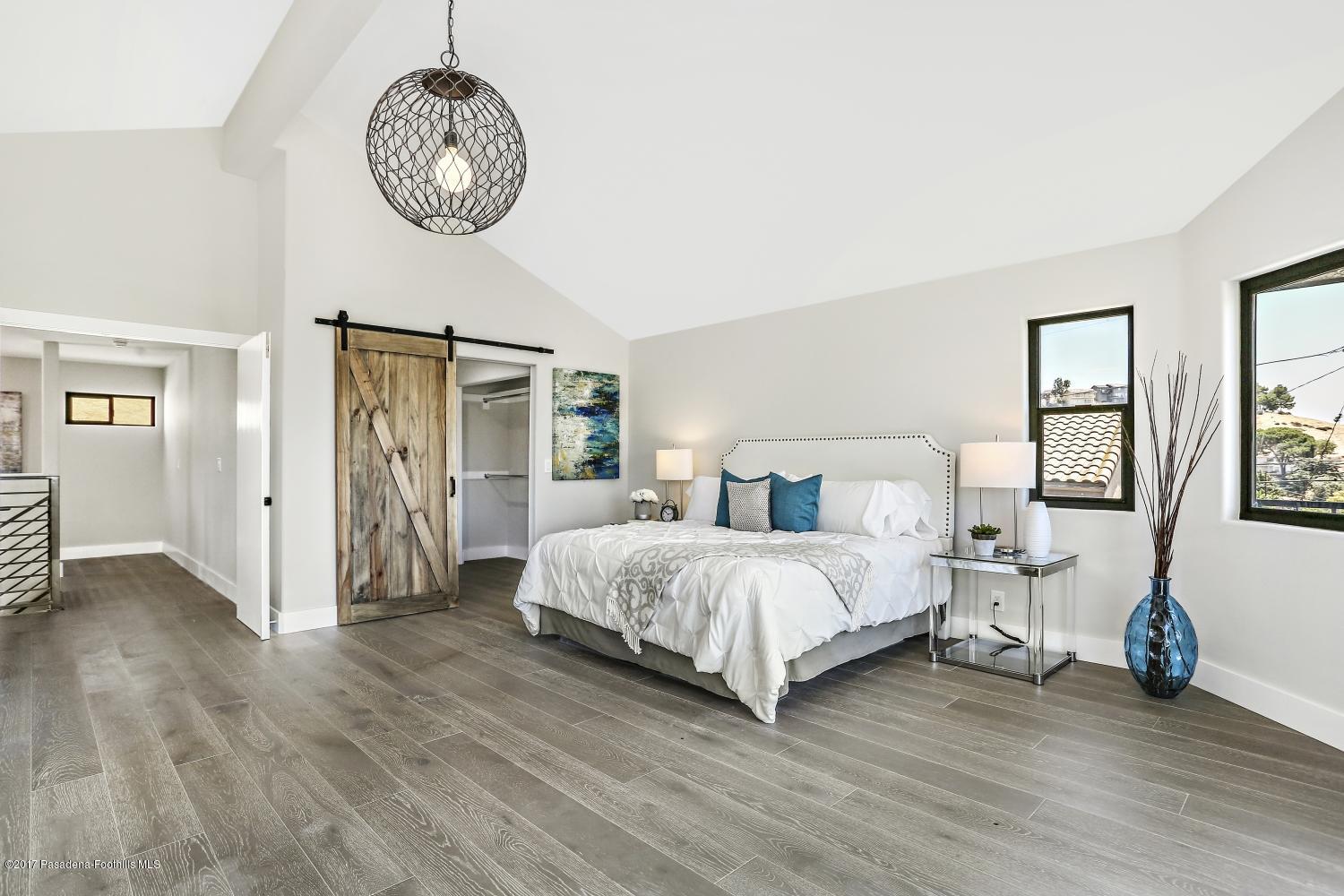 4614 Townsend Avenue Los Angeles, CA 90041 - Photo 24 of 38 a spacious bedroom with a bed a mirror and a large window