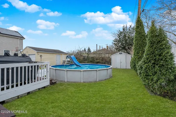a view of a backyard with a garden and deck