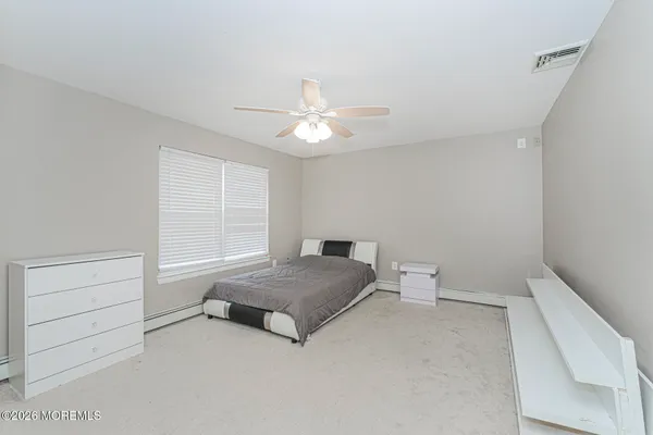 a bedroom with a bed and a ceiling fan