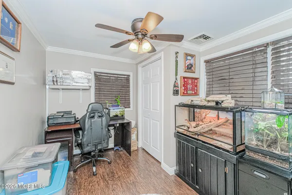 a view of a workspace with furniture and a window